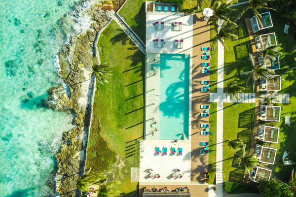 Foto aérea de um resort com uma piscina na beira do mar