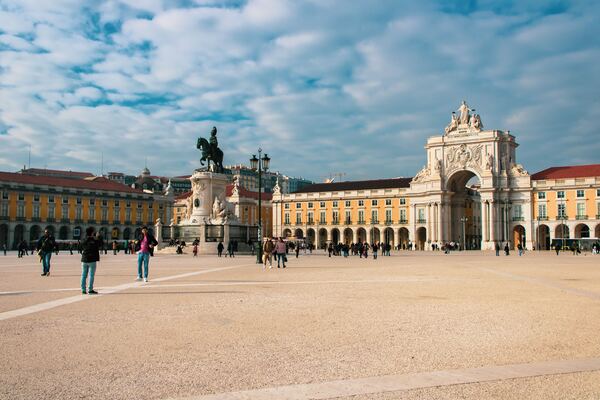 Pessoas transitam na Praça do Comércio, a última parada do roteiro de 1 dia em Lisboa. 