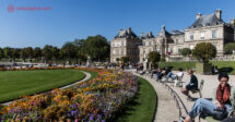 O que fazer no Quartier Latin, em Paris: o Jardim de Luxemburgo com várias pessoas sentadas ao redor do gramado em frente ao Palácio
