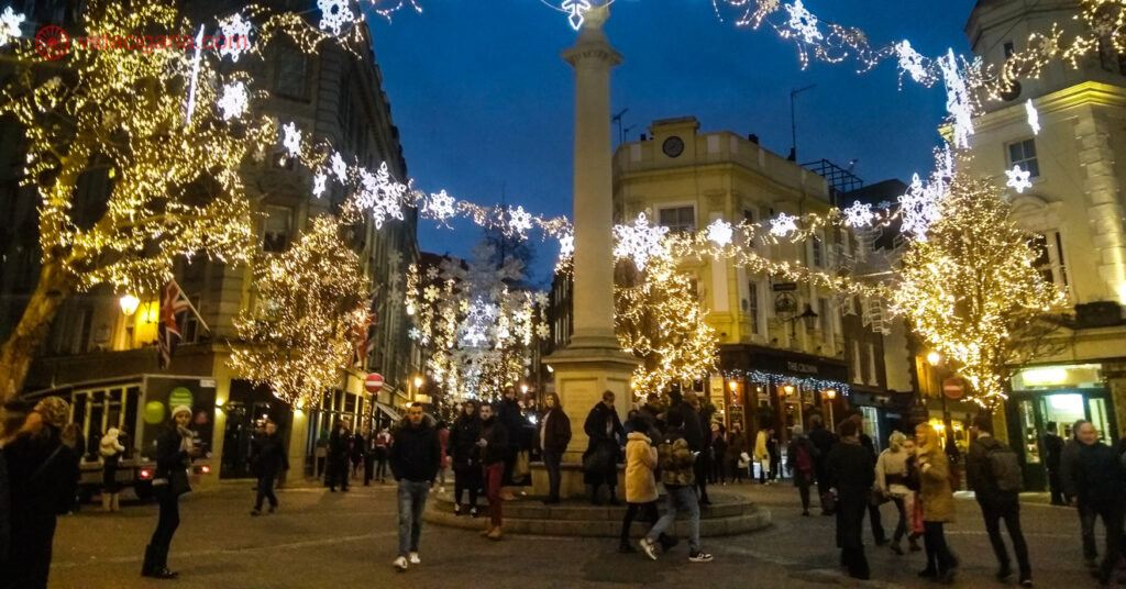 As ruas de West End enfeitadas para o Natal, com um obelisco em frente cercado de pisca-piscas.