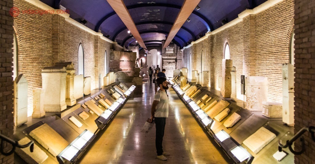 Na imagem, Carlos contempla as peças expostas em uma das salas de pedra dos Museus Capitolinos. 